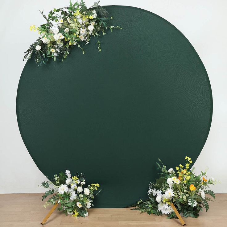 a large green circle with flowers on the top and two small white ones in front