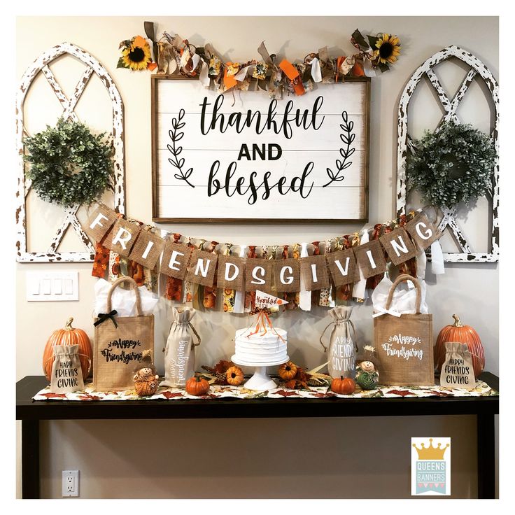 a table topped with bags and pumpkins under a sign that reads, happy thanksgiving and blessing