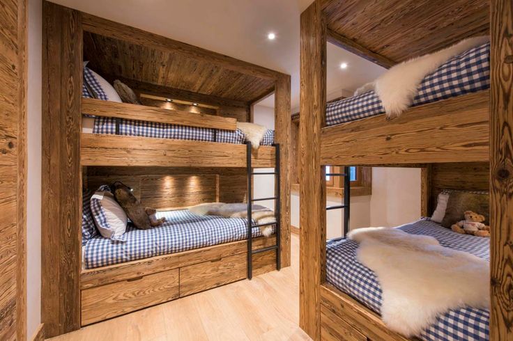 the bunk beds are made from wood and have blue checkered sheets on them,