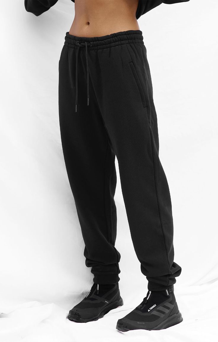 An elevated, unisex track pant made from A.T.G Sweat™ - our premium, heavy weight, 100% cotton French Terry. Featuring a limited edition embroidered logo, pair this essential with its matching crew/hoodie or layer with Sculpt™ & Vegan Puff™. 100% cotton Premium, heavy weight french terry Tonal limited edition logo embroidered on back of right leg A.T.G logo embossed metal tipped drawstring Soft inner elastic waistband for a secure yet relaxed fit Pockets in-built to side seam with colour matched Streetwear Sweats With Pockets And Straight Hem, Athleisure Sweatpants With Ribbed Waistband For Streetwear, Urban Black Pants With Ribbed Waistband, Relaxed Fit Sweatpants For Streetwear With Straight Hem, Basic Joggers With Pockets For Streetwear, Black Jogging Sweatpants With Ribbed Cuffs, Black Sportswear Sweatpants With Ribbed Cuffs, Urban Black Sweatpants With Ribbed Cuffs, Black Sweatpants With Ribbed Cuffs For Jogging