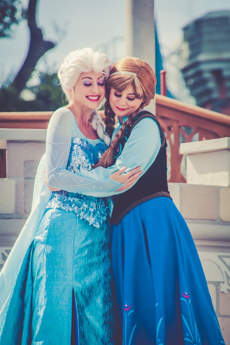 two women dressed as disney characters hugging each other