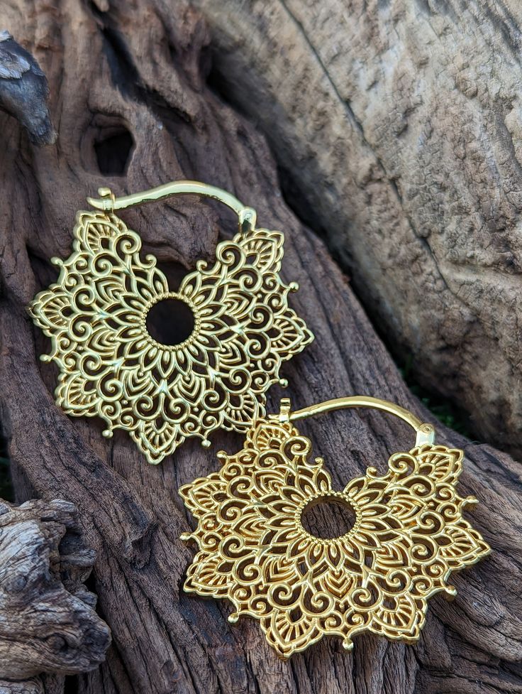 Beautiful mandala ear weights made with brass alloy and high quality gold polish.  For stretched or normal ears Custom designed and hand crafted by famed Indian artist Obi. Weight 19 gms only. #earweights #earweight #piercing #jewellery #earrings Festive Gold Brass Plug Earrings, Unique Gold Brass Cartilage Earrings, Gold Brass Plug Earrings With Intricate Design, Handmade Gold Metal Cartilage Earrings, Gold Metal Plug Earrings For Festivals, Gold Brass Plug Earrings For Festivals, Handmade Gold Cartilage Earrings, Festival Gold Brass Plug Earrings, Festival Yellow Gold Brass Jewelry