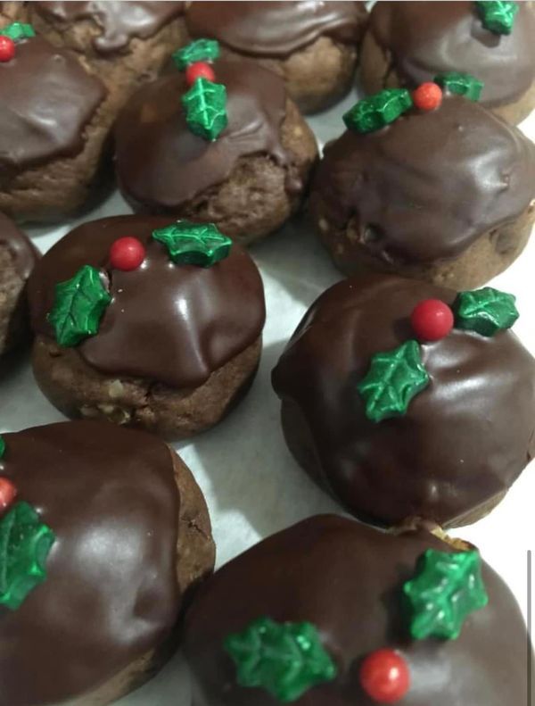 chocolate covered cookies decorated with holly leaves and red berries