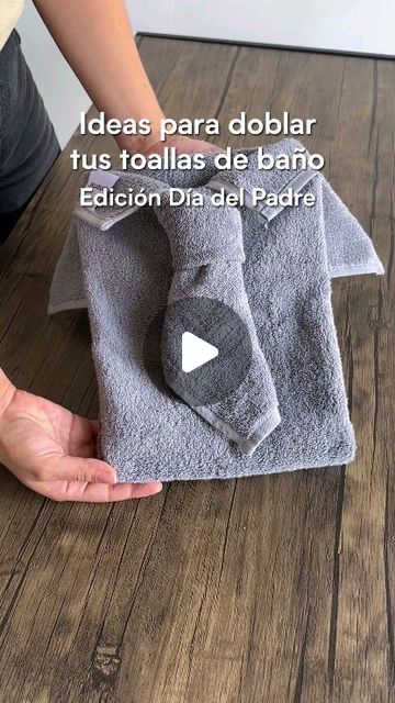 a person is holding two towels on the floor with words written in spanish and english