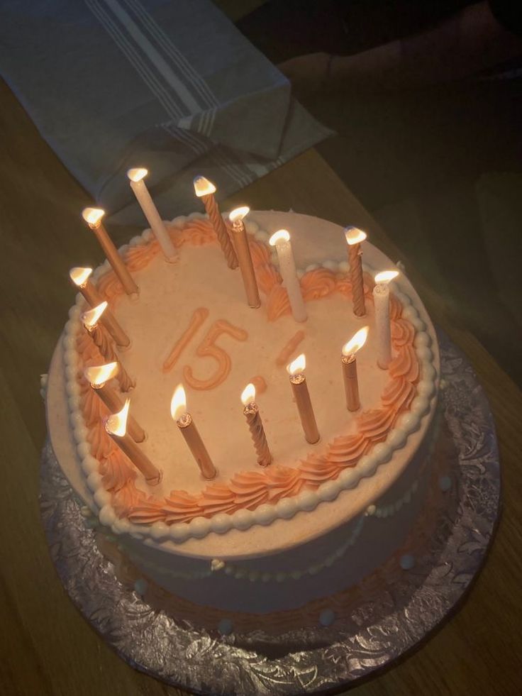 a birthday cake with lit candles on it