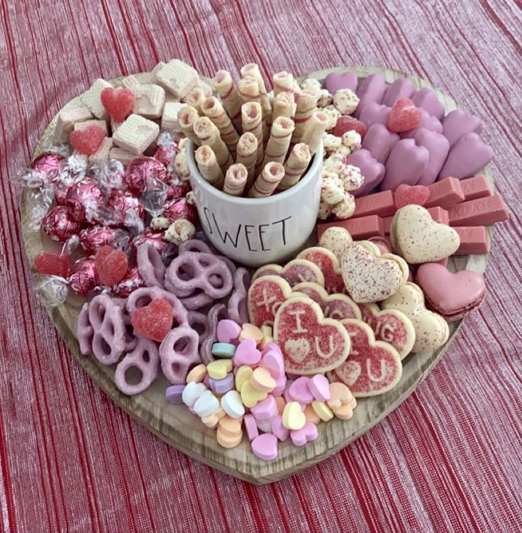 a heart shaped platter filled with valentine's treats