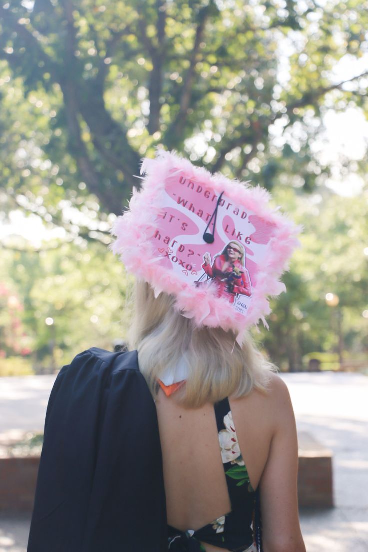 the back of a woman's head with a pink hat on top of it