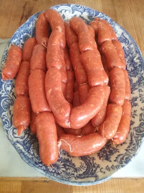 a blue and white plate topped with lots of hot dogs