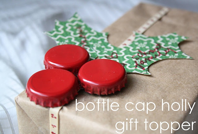 three red bottle caps sitting on top of a wrapped present