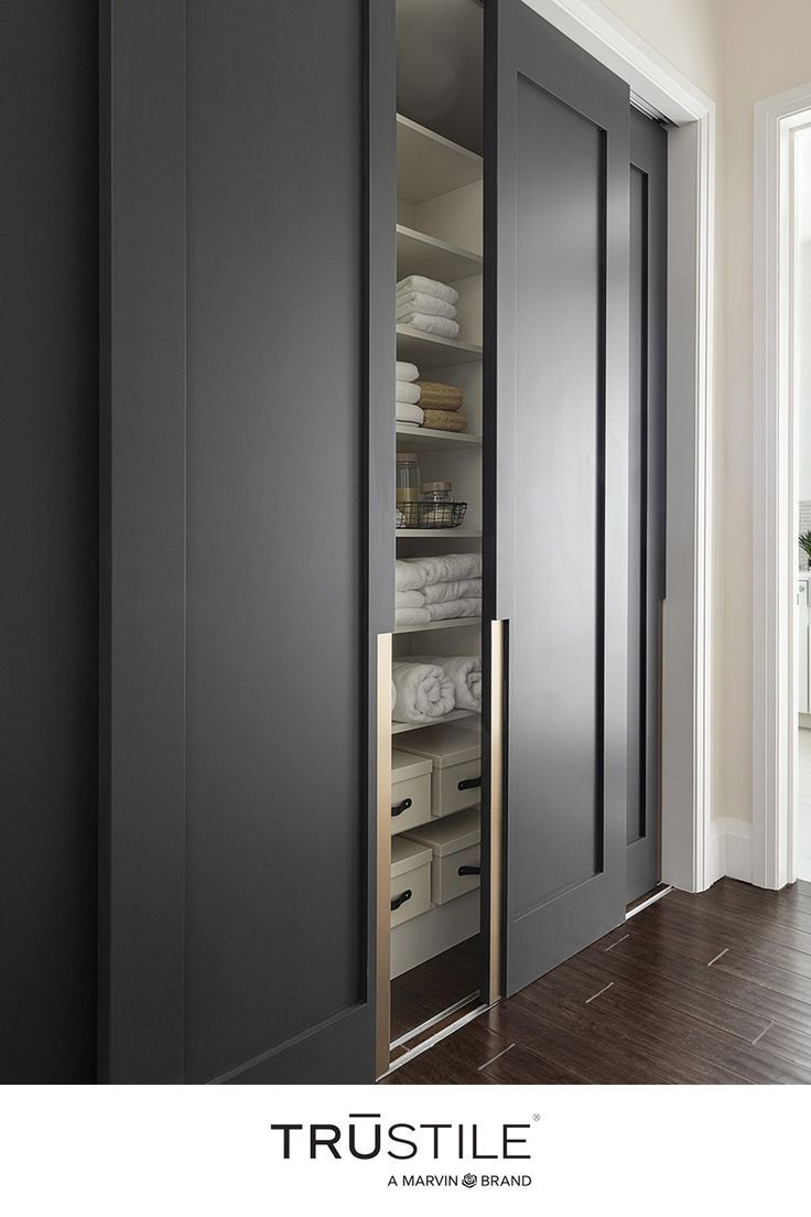 an image of a closet that is in the middle of a room with its doors open