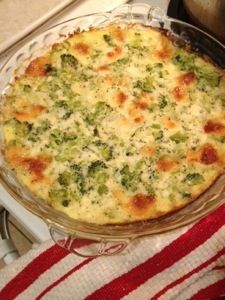 a casserole with broccoli and cheese in a glass dish on top of a stove