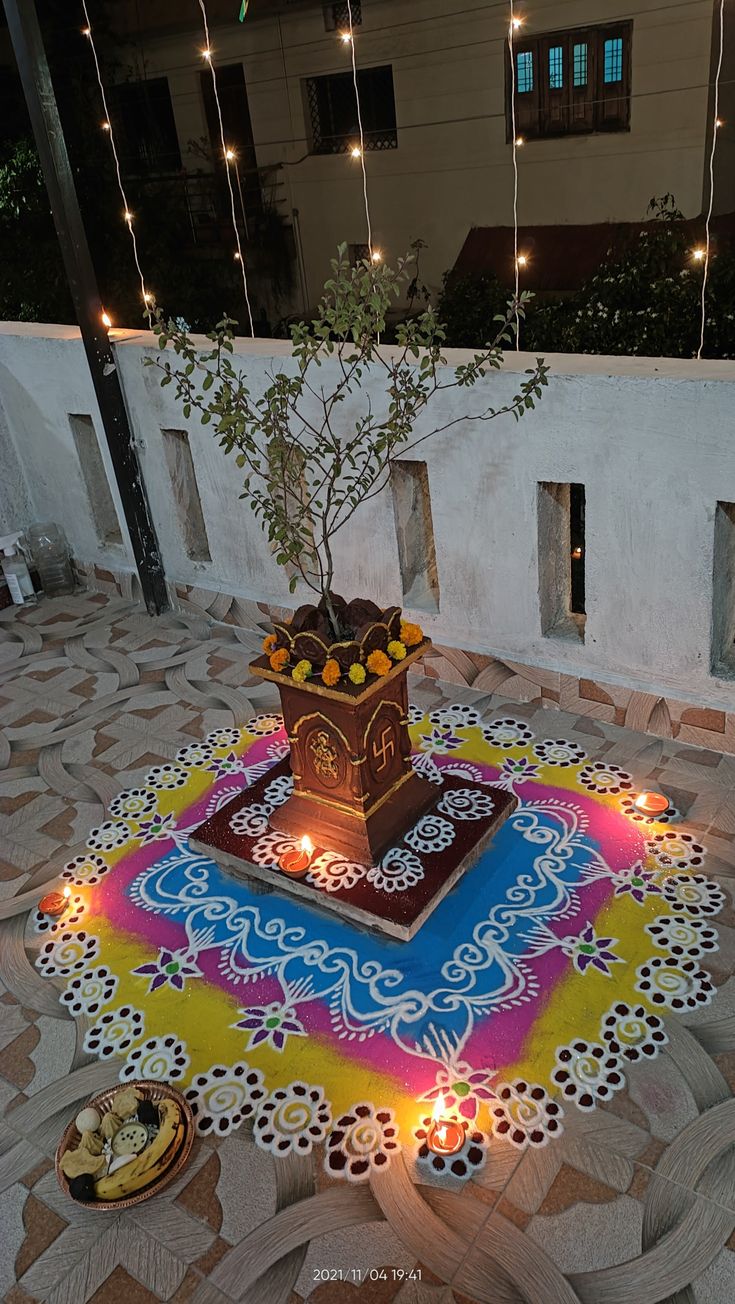 a decorated floor with lit candles and a tree in the center on top of it