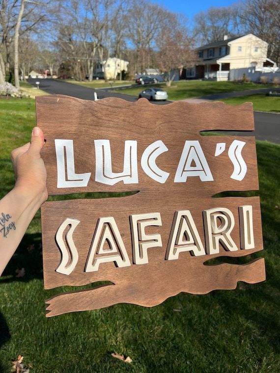 someone holding up a sign that says lucas's safari