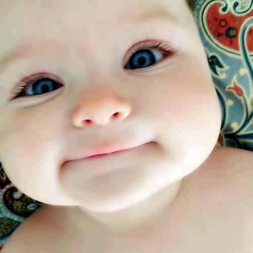 a close up of a baby with blue eyes