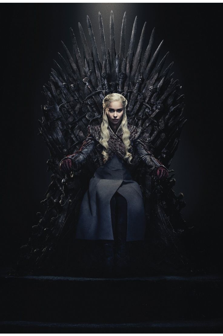 a woman sitting on top of a iron throne