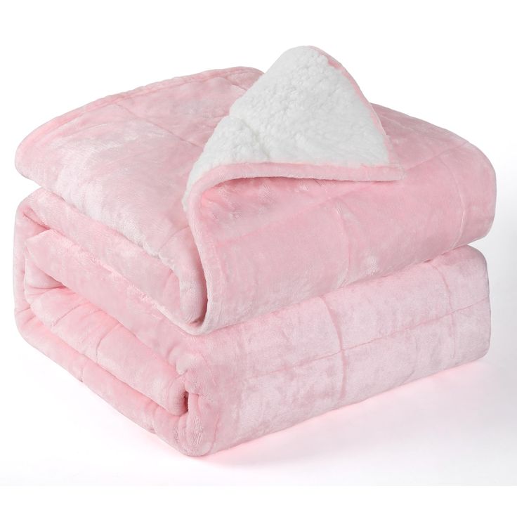 a pink and white blanket sitting on top of each other