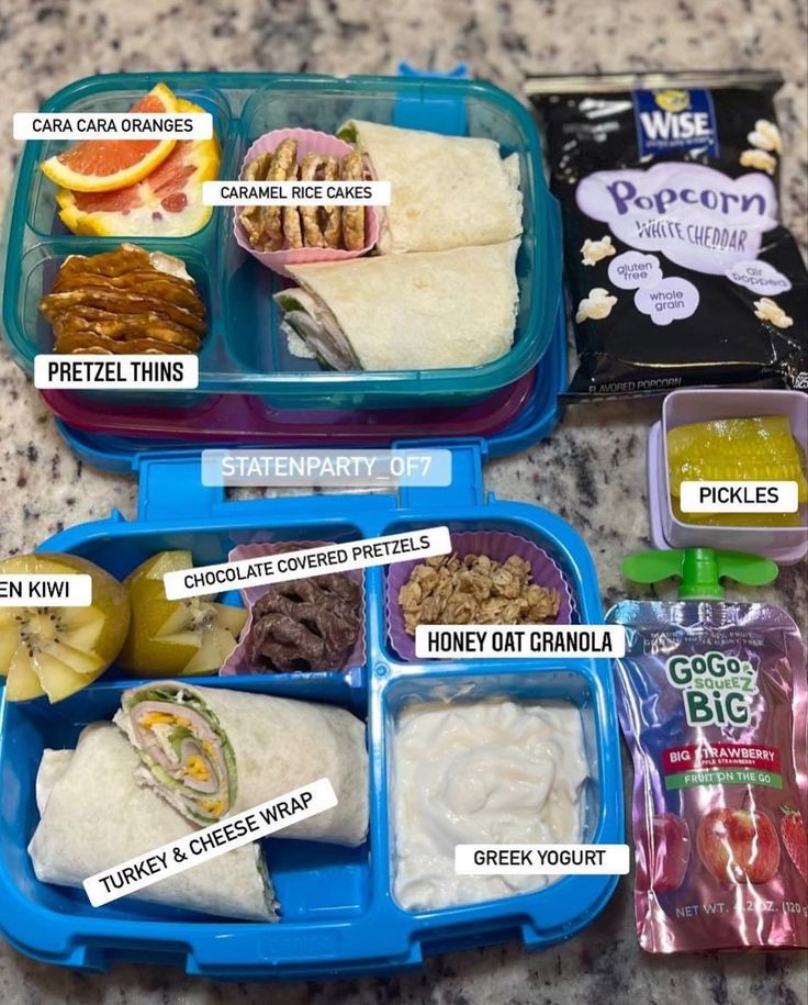 three plastic containers filled with food on top of a counter