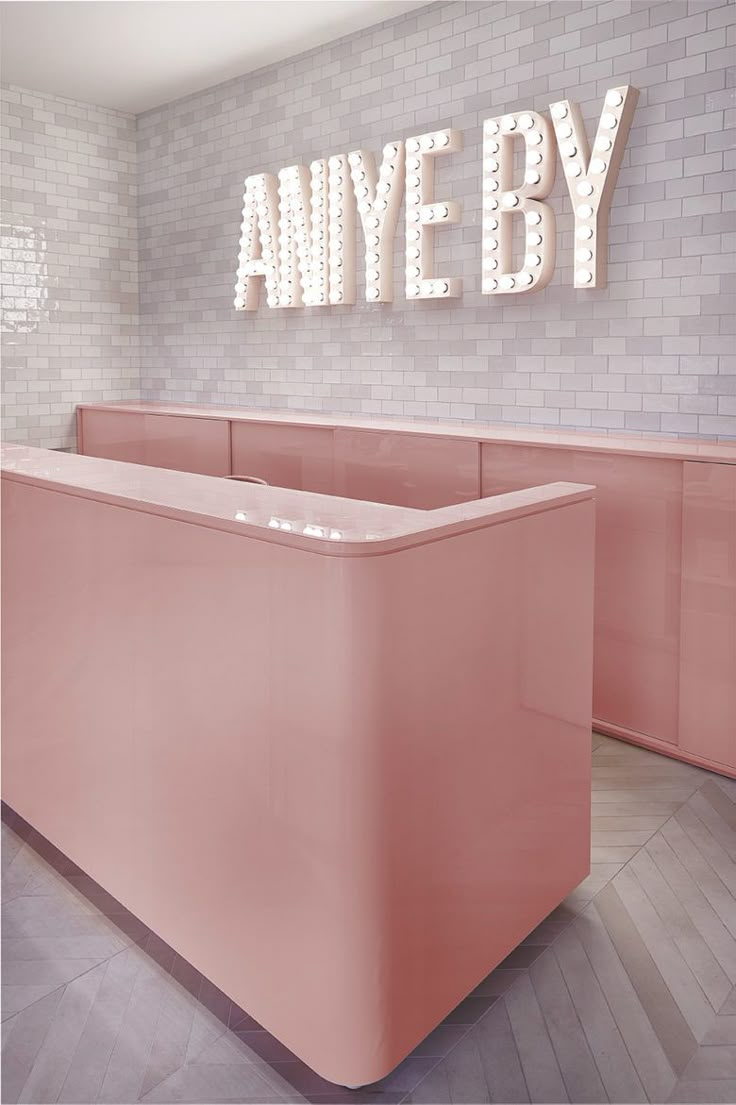 an empty pink counter in front of a sign that says,'ahve by '