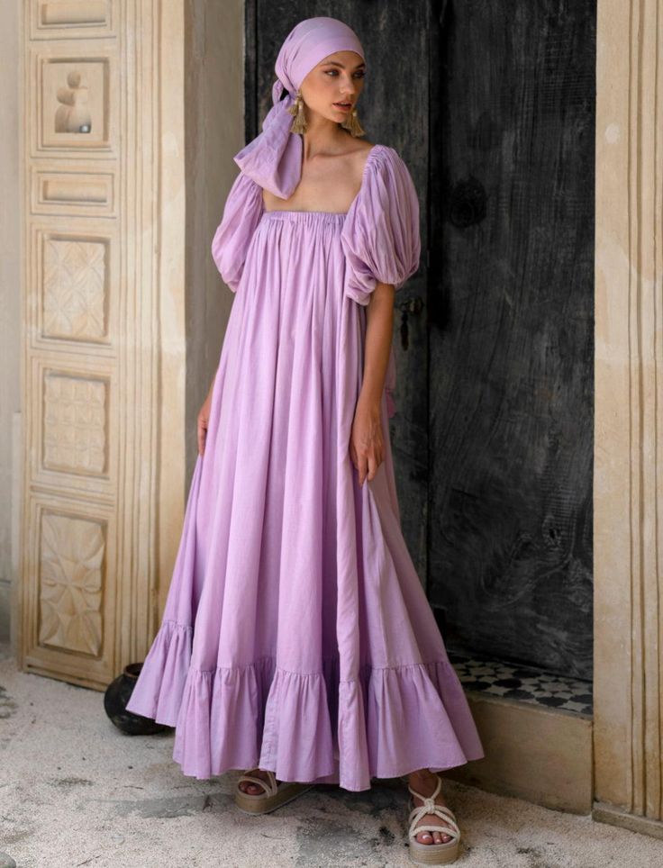 EDITOR NOTE// The modest sister to our Karina Flowing dress. We showcase this piece which encapsulates our affinity to feminine silhouettes fused with bohemian aesthetics. This dress features delicate-yet-exaggerated detachable puff sleeves for an effortless yet romantic day-to-night look. DESIGN NOTE//Off the shoulder floor length maxi dress with elastic neckline and cap-billowy sleeves that can be removed. This dress consumes 14.5 meters of hand-dyed cotton voile fabric and takes 13 hours of s Off Shoulder Cotton Dress, Modest Modern Outfits, Detachable Puff Sleeves, Western Style Dresses, Stylish Prom Dress, Modest Maxi Dress, Floor Length Maxi Dress, Diy Tutu, Billowy Sleeves