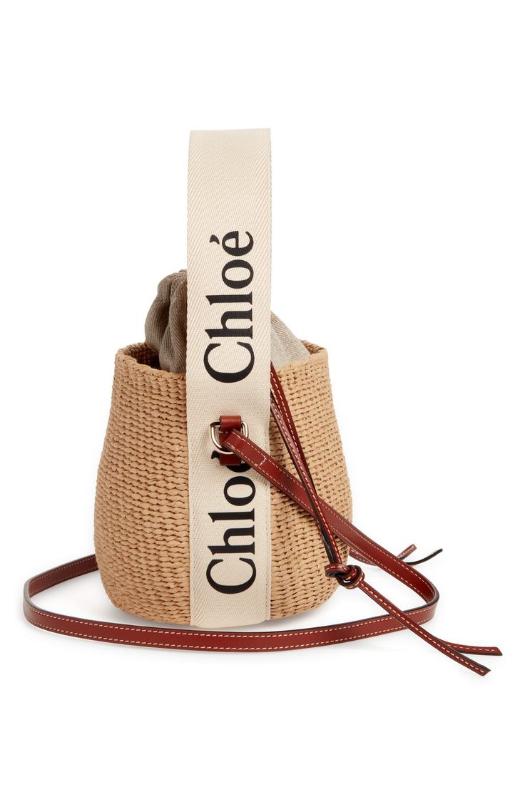 a brown and white bag sitting on top of a red strap