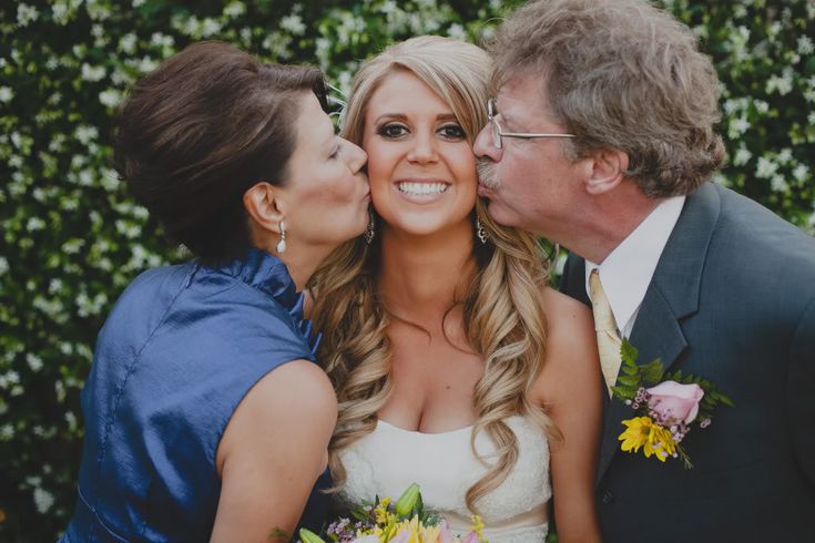 two women and a man are kissing each other