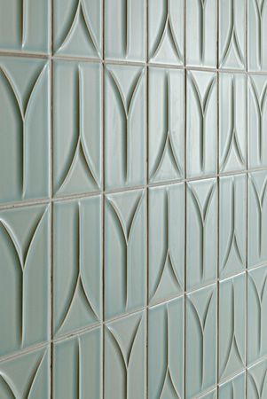 a close up view of a wall made out of ceramic tiles with wavy lines on it