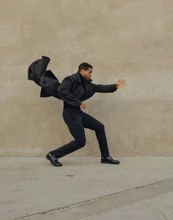 a man is running with an umbrella in his hand