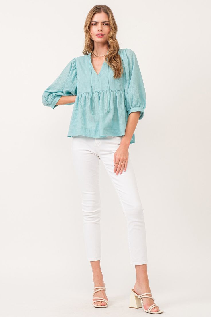 image of a female model wearing a MALIA V-NECK TOP BIO MINT DEAR JOHN DENIM Chic Linen Peasant Top For Spring, Chic V-neck Peasant Top Relaxed Fit, Chic Relaxed Fit V-neck Peasant Top, Spring Split Neck Blouse For Brunch, Casual Cotton V-neck Top For Spring, Spring Cotton Peasant Top With Relaxed Fit, Chic V-neck Top In Relaxed Fit For Spring, Chic Green Blouse With 3/4 Sleeves, Chic Relaxed Fit Cotton Peasant Top