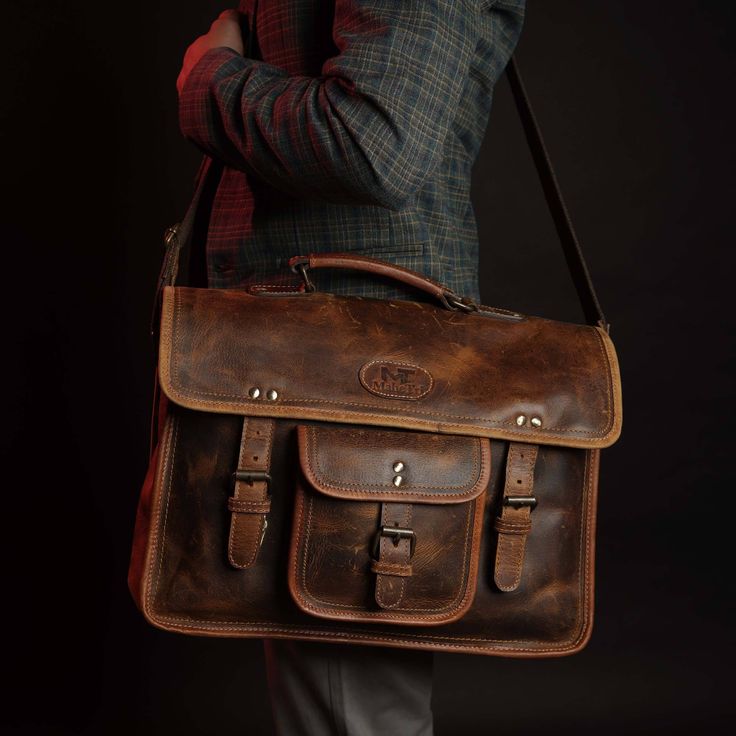 Trustpilot The man who follows the old-school style would never face formal or informal rejection. The Roosevelt buffalo leather satchel bag is designed to keep in mind a pure handmade and vintage look with excellent modern craftsmanship. This bag is wrapped perfectly with canvas and well stitched with hard Nylon thread. This bag looks like a Leather laptop satchel with a vintage look that goes rich in color with time. The bag comprises 3 major compartments including a soft padded which can hold Rectangular Waxed Canvas Satchel For School, Business Satchel In Vintage Brown, Classic Waxed Canvas Satchel For Everyday Use, Business Vintage Brown Shoulder Satchel, Classic Waxed Canvas Bag With Leather Backing, Waxed Finish Satchel Shoulder Bag For School, School Satchel With Waxed Leather Finish, Vintage Brown Business Satchel, Rectangular Waxed Finish Shoulder Bag For School