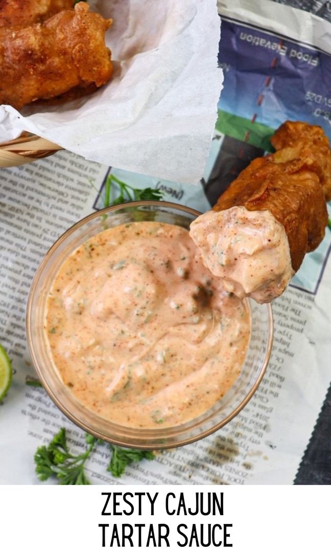 a bowl filled with tastyy cajun tartar sauce next to fried chicken wings