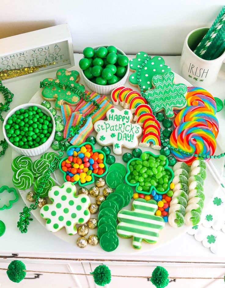 an assortment of st patrick's day cookies and candy