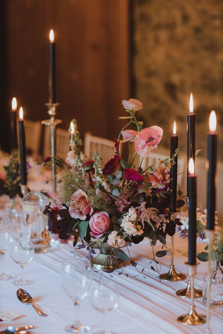 the table is set with candles and flowers