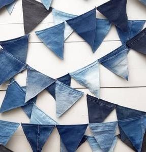 blue jeans hanging from the side of a wall with black and white triangles on it