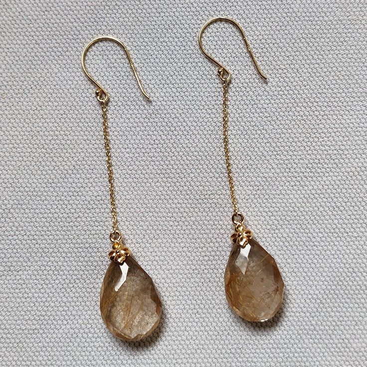 **KINDLY CHECK OUT THE VIDEO OF THE ITEM FOR A CLEARER VIEW**Details of the earrings Gemstone : Golden Rutilated quartz Gemstone weight: 17.09 carats Gemstone shape and size: pear , 18x12 mm Metal: GOLD Purity: 14K Gold Weight: 1.12 grams Total weight: 4.54 grams Natural golden rutile gemstones set in solid 14k yellow gold studs. The Gold purity is absolutely guaranteed and it comes with an authentic 14 k gold hallmark. Since these earrings are handmade, Gemstone customization is available and t Gold Briolette Earrings, 14k Gold Briolette Earrings, Faceted 14k Gold Earrings For Formal Occasions, Faceted Long Drop Jewelry For Anniversary, 14k Gold Faceted Earrings For Formal Occasions, 14k Gold Briolette Jewelry With Matching Earrings, 14k Gold Briolette Pierced Jewelry, Pierced Briolette 14k Gold Jewelry, Formal 14k Gold Faceted Earrings