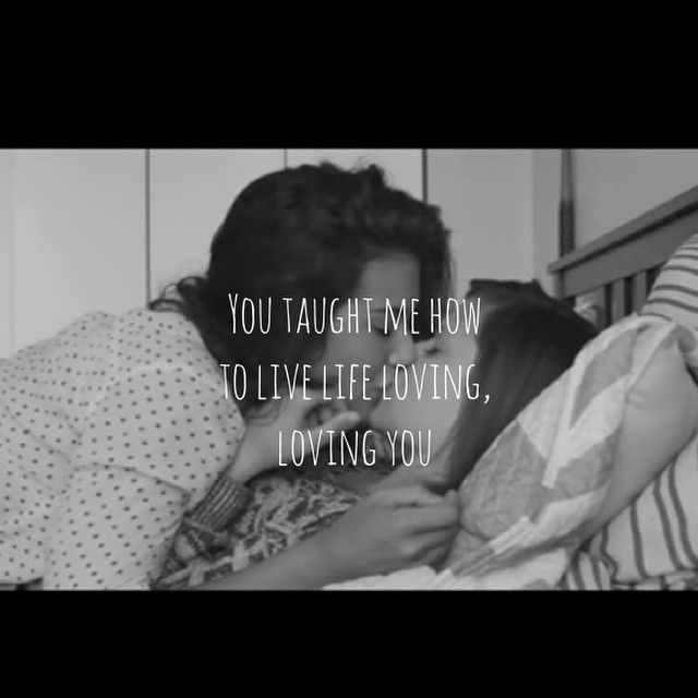 a woman laying in bed next to a man with his arm around her head and the words you taught me how to live life loving, loving you