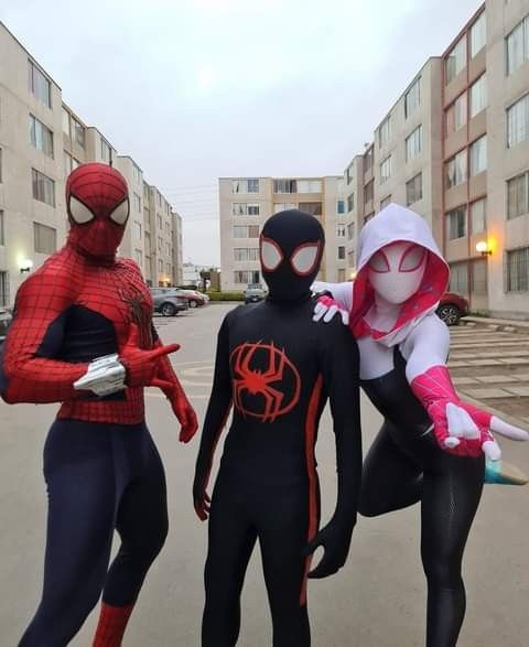 three spider - man cosplay standing next to each other