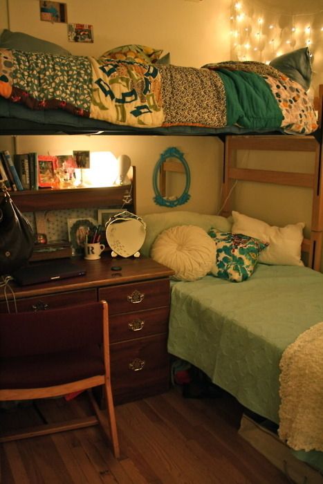 two bunk beds in a bedroom next to each other with lights on the wall above them