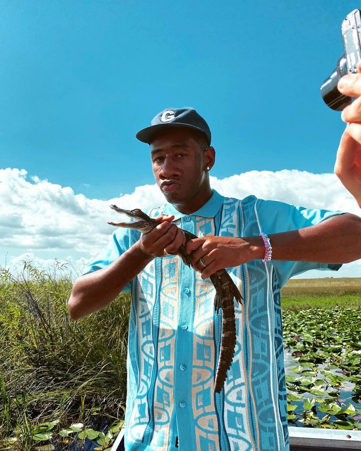 a man holding a bird in his hands