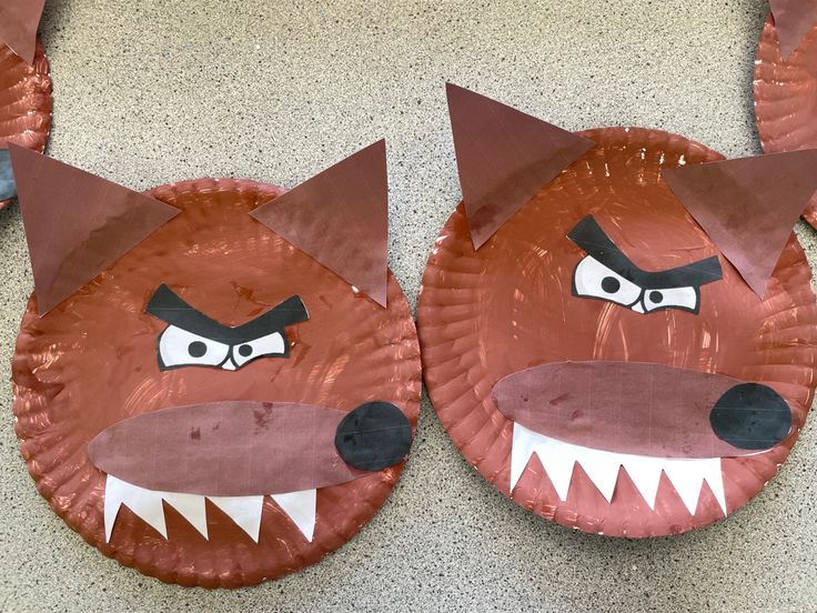 two paper plates with angry animals on them, one is red and the other has white teeth