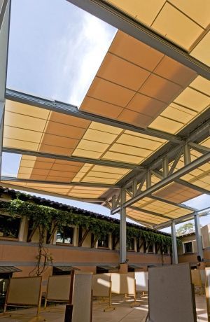 an outdoor covered area with tables and chairs