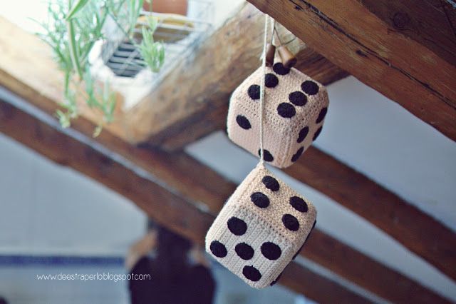 two white and black dices hanging from strings