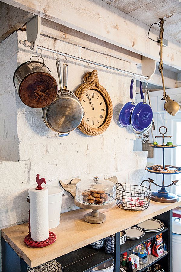 a kitchen with pots and pans hanging on the wall