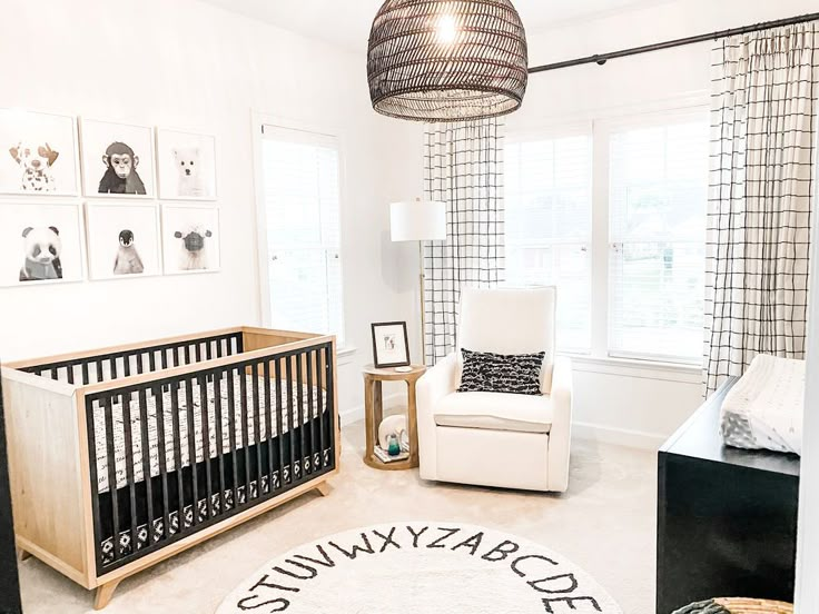 a baby's room is decorated in white and black