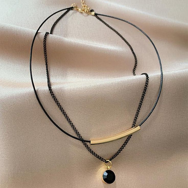 ✦ Indulge in the sophistication and exclusivity of this stunning two-layer necklace. Elevate any outfit and exude effortless style with this elegant, yet seductive piece. Expertly crafted with premium materials and a delicate design, it is a must-have for any fashion-forward individual. Be the subject of envy among your peers with this sleek black necklace. The perfect present for a loved one, be it your significant other, mother, sister, or daughter. ----------- DETAILS ----------- Color: Black Size (Length): 33.5cm (inner); 36.5cm (outer) Extension Chain Length: 7cm Materials: 316L Surgical Steel, 18K Gold Plated, Cubic Zirconia, Faux Leather *316L Stainless Steel is hypoallergenic, generally safe for sensitive skin. - SKU: HN518 Elegant Double Strand Metal Chain Necklace, Elegant Layering Choker Necklace, Minimalist Double Chain Layered Necklace For Parties, Elegant Adjustable Double Chain Necklaces, Minimalist Clavicle Chain Choker For Formal Occasions, Elegant Multi-strand Metal Choker, Minimalist Formal Choker With Clavicle Chain, Adjustable Chic Layered Clavicle Necklace, Elegant Double Strand Metal Layered Necklace