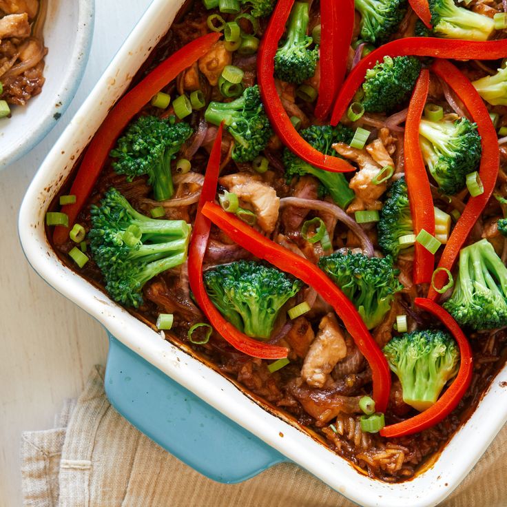 a casserole dish filled with broccoli, red peppers and chicken stir fry