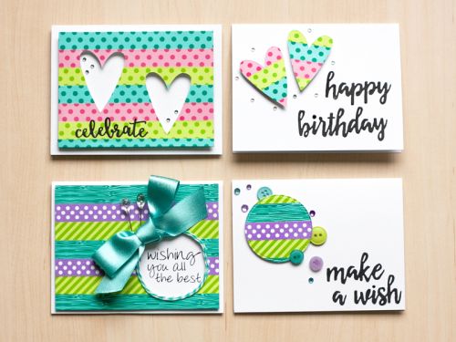 four handmade birthday cards with different designs on the front, one has a bow and two have hearts