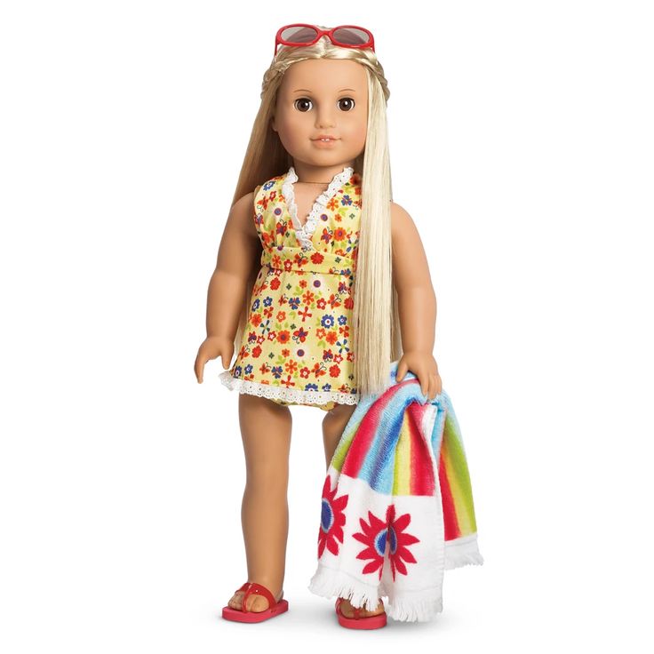 a doll with blonde hair and sunglasses holding a beach bag