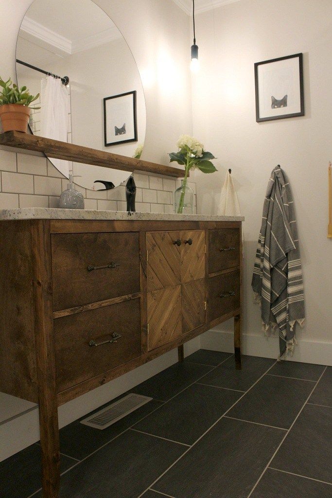 a bathroom with a sink, mirror and towel rack