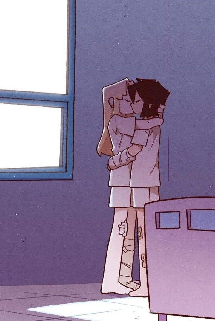 two people hugging each other in the middle of a room with blue walls and windows