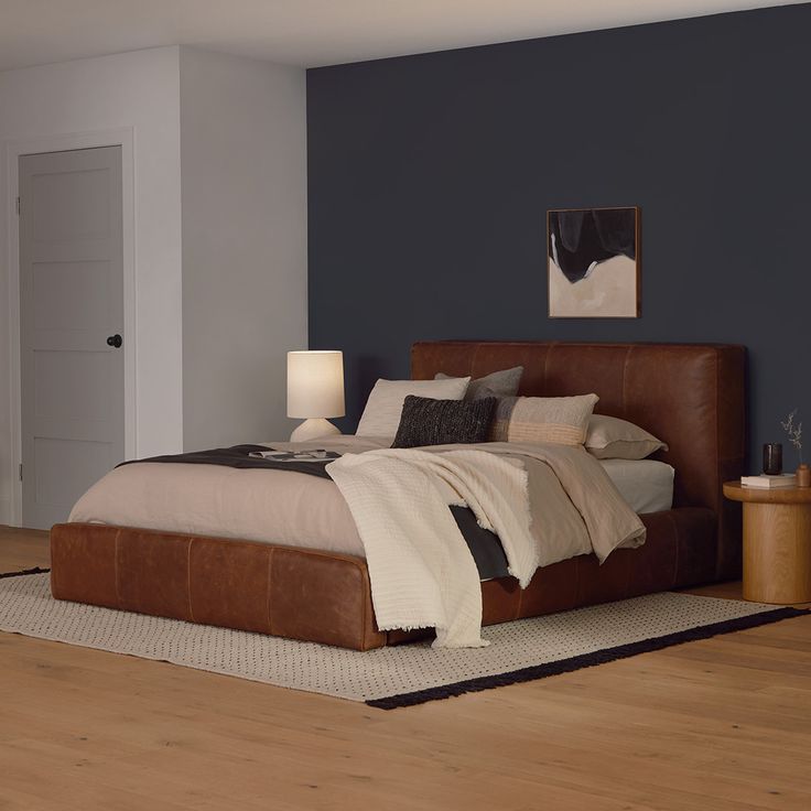 a large bed sitting on top of a wooden floor